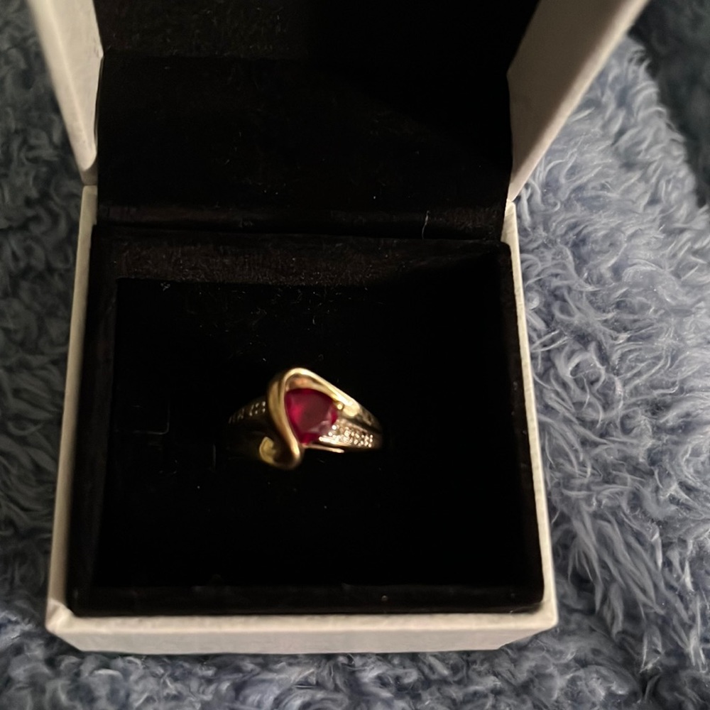 Stamped 10k ruby with mini diamonds gold ring.  Size 6